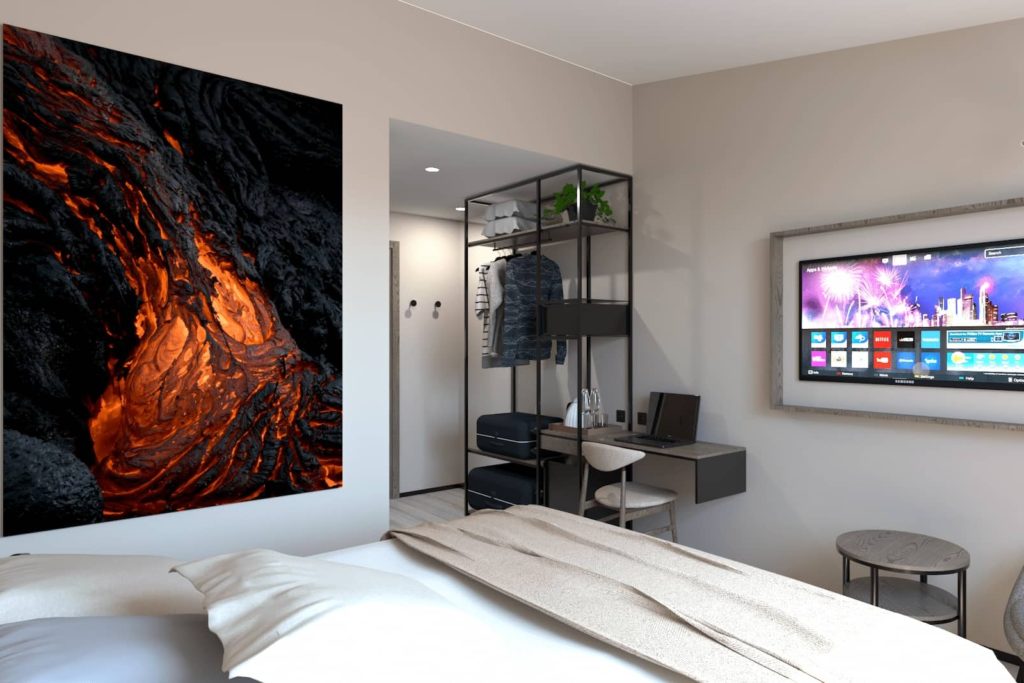 Deluxe volcano room with bed and TV